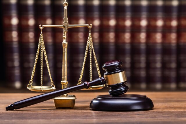 Wooden,Gavel,With,Golden,Scale,On,Table